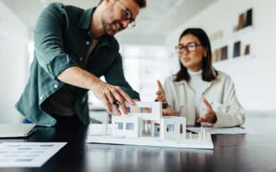 architects working on a house model in an office