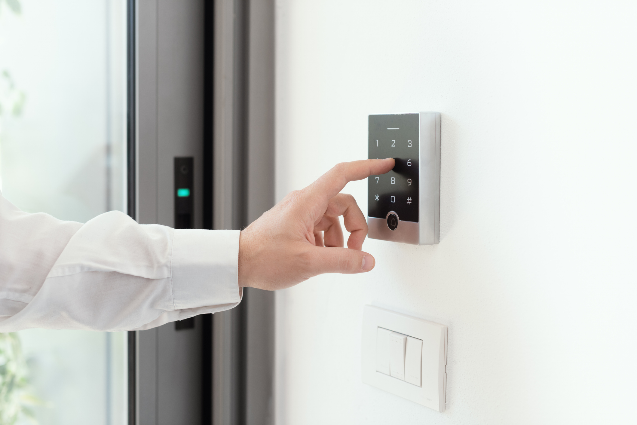 man setting an alarm code for home security