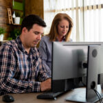 man and female manager talking in modern business office