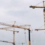 huge cranes against the blue sky. construction background.