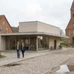 Modernes Dorfzentrum im ländlichen Umfeld. KI-generiert